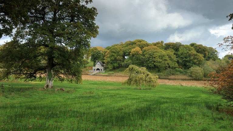 View of the boathouse across the parkland at Crom, County Fermanagh